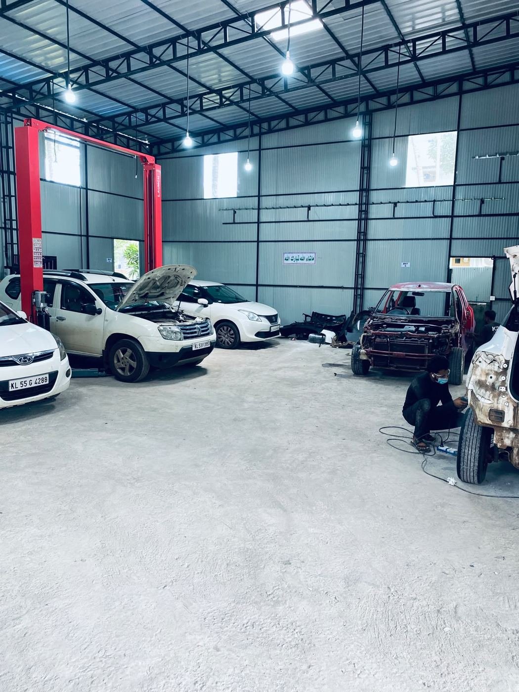 Service bays at Thenath Motors with vehicles under repair